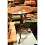 A reproduction wine table having scalloped oval top