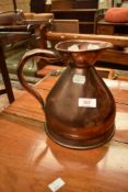 A 19th Century copper measure jug, having touche marks to spout