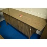 A modern bespoke Ercol sideboard, Silver mist design, with slide out cocktail section to centre,