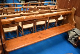 A traditional pitch pine pew, width 210cm