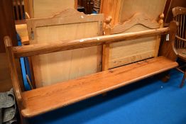 A traditional pitch pine pew, width 210cm