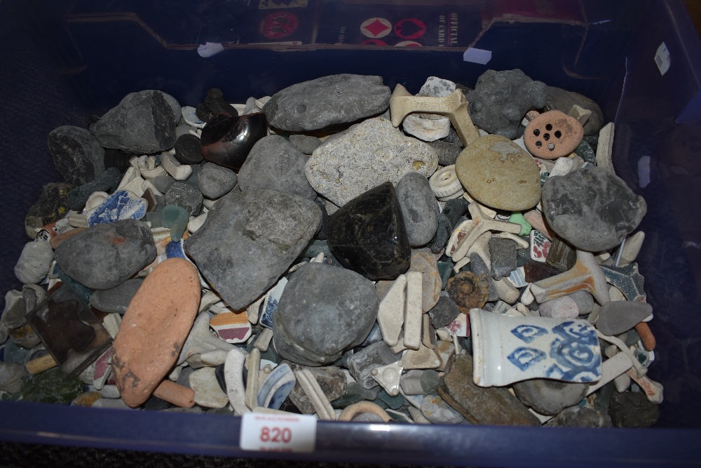 A box full of pebbles, shards of pottery and sea glass.