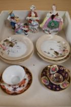 A miniature Royal Crown Derby cup and saucer and similar example, four whimsical figurines and