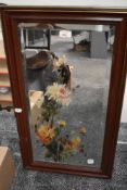 A bevelled glass mirror in wood frame, having hand painted floral design.