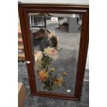 A bevelled glass mirror in wood frame, having hand painted floral design.