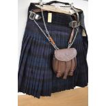 A vintage kilt in green and blue (32 inch waist approx) having some moth damage.