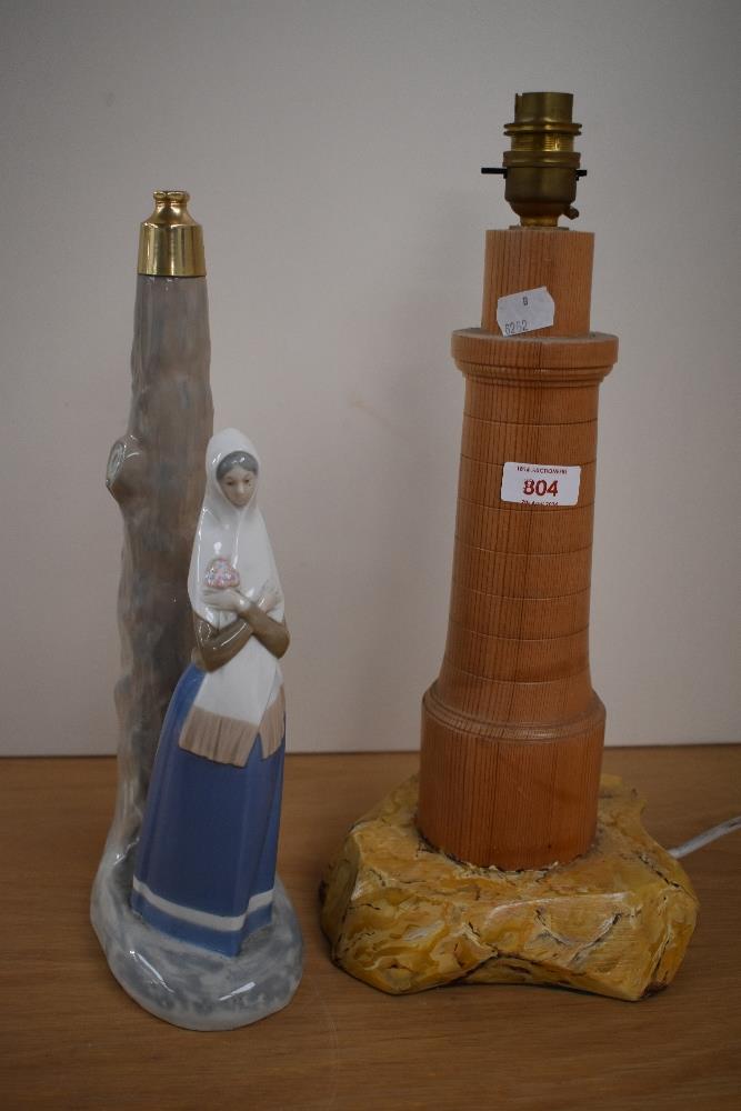 A lladro, or Lladro style lamp base and a turned wood lamp base.