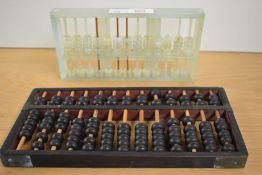 A jadeite two tier abacus, measuring 23cm long, and another abacus