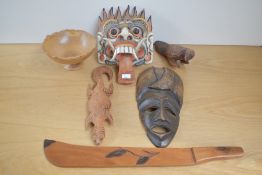 An assorted collection of African carved masks and other hardwood items