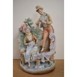 A 19th Century continental bisque porcelain figure group of a courting couple, the rear impressed