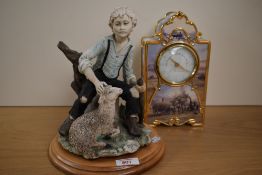 A cast Capo-di-Monte style shepherd figure, depicting a young boy sat on a tree stump, marked BA, on