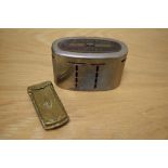 A vintage District Bank money box and a Victorian brass needle case.