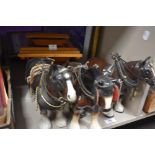 Three ceramic Shire Horse studies sold along with a wooden cart.