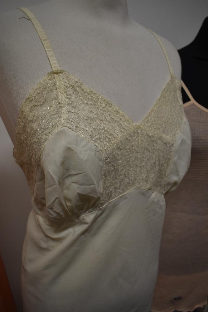 A selection of vintage lingerie, to include CC41 utility labelled knitted slip, 1930s peach slip and - Image 2 of 7