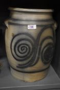A decorative 20th Century stoneware slop pail, the moulded rim above a spiralled design, with two