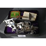 A vintage Singer sewing machine tin, containing a selection of Singer sewing machine attachments,