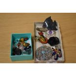 An assortment of costume jewellery brooches and pins including a large paste set brooch of a pierced