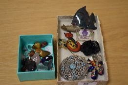 An assortment of costume jewellery brooches and pins including a large paste set brooch of a pierced