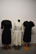 Two 1950s dresses, one in cream having pleated skirt with bow detail to front with Peter Pan collar,