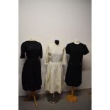 Two 1950s dresses, one in cream having pleated skirt with bow detail to front with Peter Pan collar,