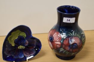A William Moorcroft pottery vase, tube lined and in the Anemone pattern on blue ground, measuring