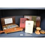 A selection of vintage pharmaceutical items, including pill roller and closing machine, books, and