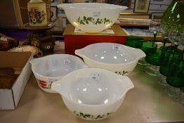 Four retro Pyrex oven to tableware bowls, three having green vine leaf design and one a vegetable