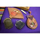 Two antique coin burses, a 1930s handkerchief case, a wooden box of buttons and trinkets and two