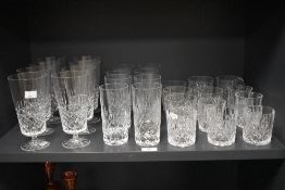 A collection of cut crystal glassware, including footed water glasses and whisky tumblers