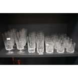 A collection of cut crystal glassware, including footed water glasses and whisky tumblers