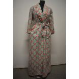 A 1940s/50s cotton housecoat, having bright rose pattern on grey striped white ground, with shoulder