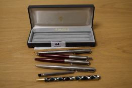 A collection of vintage pens, including a Sheaffer Italic F fountain pen, a Parker fountain pen, and