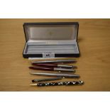 A collection of vintage pens, including a Sheaffer Italic F fountain pen, a Parker fountain pen, and