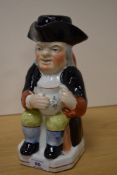 A Victorian Staffordshire Toby jug or pitcher, with stopper, measuring 24cm tall