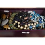 An assortment of costume necklaces including various beaded examples, statement pieces and faux