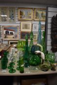 A large selection (29 pieces approx) of mid century glassware in shades of green including decanters