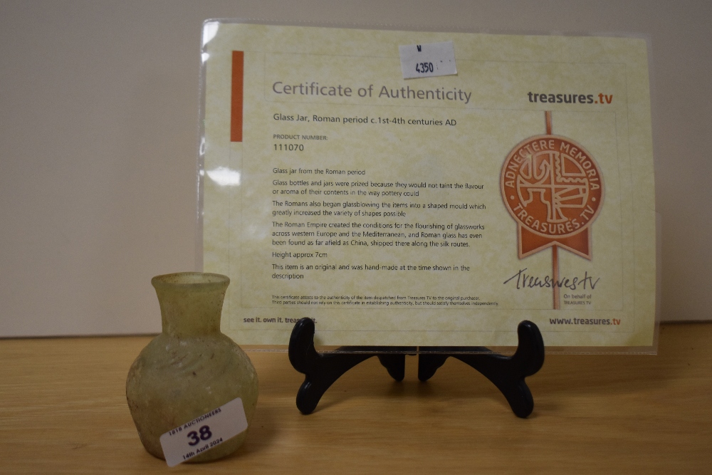 A small Roman glass jar, c.1st-4th Century AD, measuring 6cm tall, with certificate of authenticity
