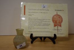 A small Roman glass jar, c.1st-4th Century AD, measuring 6cm tall, with certificate of authenticity