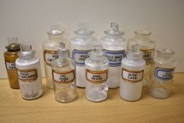 A selection of ten vintage glass apothecary/chemists jars, having various labels.