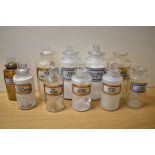 A selection of ten vintage glass apothecary/chemists jars, having various labels.