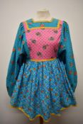 A really fun 1960s smock, in bright floral patterns, having huge sleeves and rear metal zip.