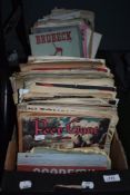 A box full of vintage sheet music and music scores.