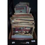 A box full of vintage sheet music and music scores.