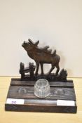 A carved treen ink well/pen stand of primitive form, bearing inscription, having Moose decoration to