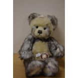 A long pile plush Charlie Bear teddy bear, 'Lewis', with brown collar and bell, measuring 34cm tall