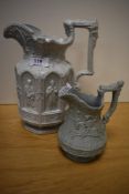 Two Victorian jugs, both having pale blue ground with relief designs, one with apostle decoration