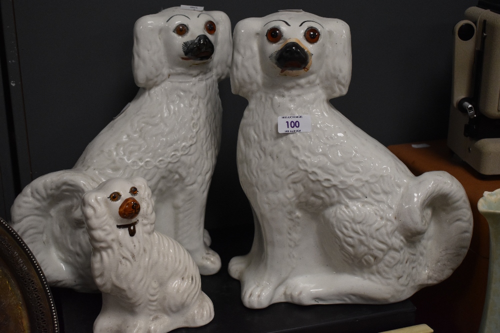 Two Staffordshire pottery dogs and a similar smaller example. - Image 2 of 4