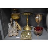 An antique oil lamp with cast metal base (void of chimney) a cruet set, a letter rack, a silver