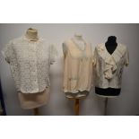 Three vintage blouses, including 1950s cream silk blouse with ruffles to front.