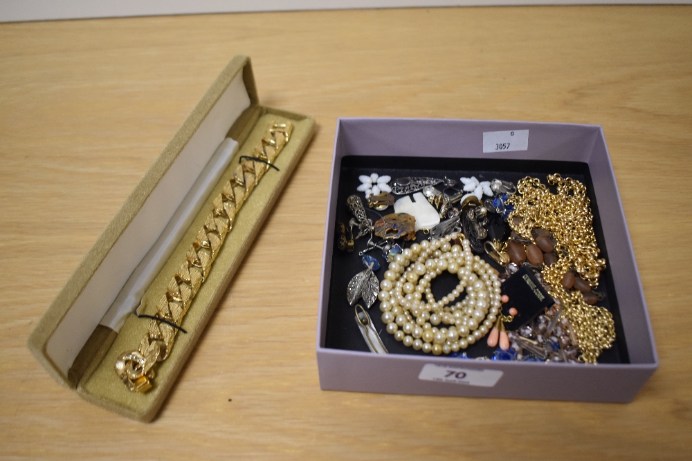 An assortment of costume jewellery including faux pearls, a pair of coral drop earring, various clip